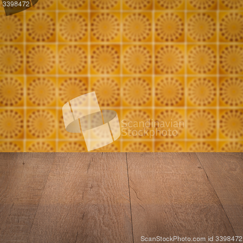 Image of Wood table top and blur vintage ceramic tile pattern wall