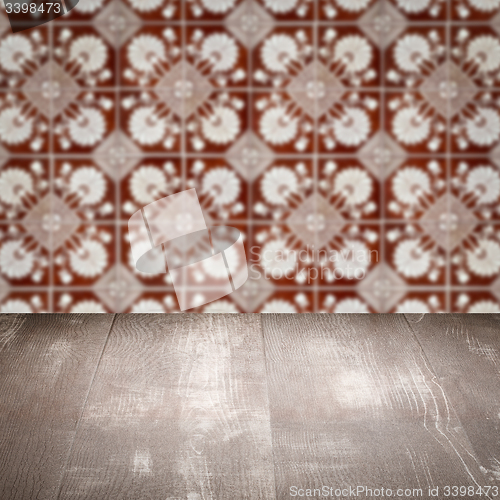 Image of Wood table top and blur vintage ceramic tile pattern wall