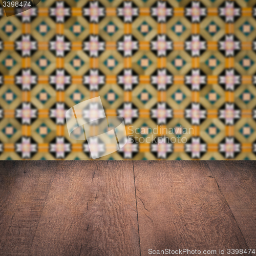 Image of Wood table top and blur vintage ceramic tile pattern wall