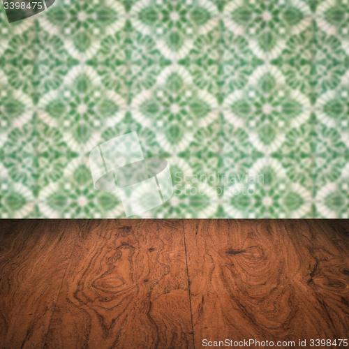 Image of Wood table top and blur vintage ceramic tile pattern wall