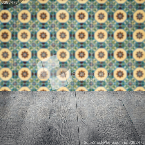Image of Wood table top and blur vintage ceramic tile pattern wall