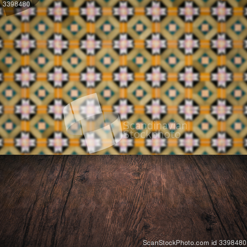 Image of Wood table top and blur vintage ceramic tile pattern wall