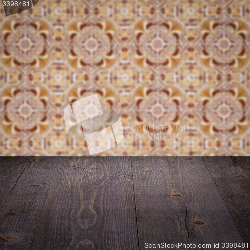 Image of Wood table top and blur vintage ceramic tile pattern wall