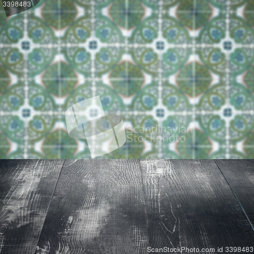 Image of Wood table top and blur vintage ceramic tile pattern wall