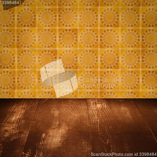 Image of Wood table top and blur vintage ceramic tile pattern wall