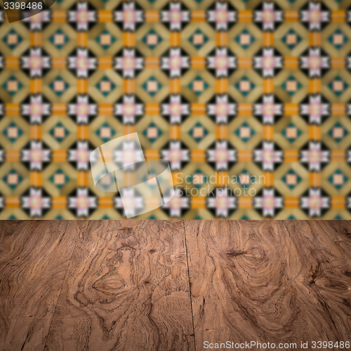 Image of Wood table top and blur vintage ceramic tile pattern wall