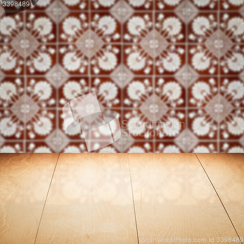 Image of Wood table top and blur vintage ceramic tile pattern wall