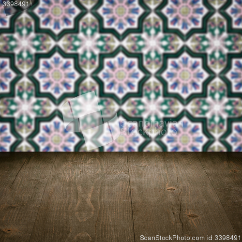 Image of Wood table top and blur vintage ceramic tile pattern wall