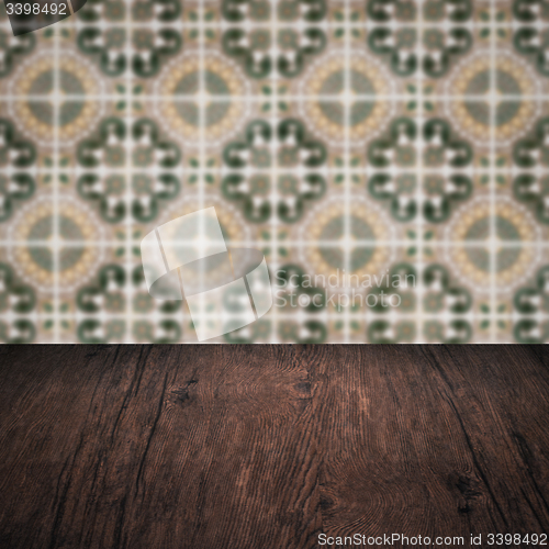 Image of Wood table top and blur vintage ceramic tile pattern wall