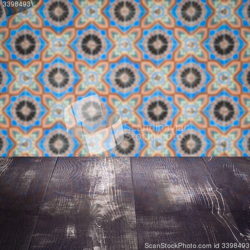 Image of Wood table top and blur vintage ceramic tile pattern wall