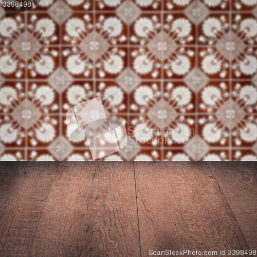 Image of Wood table top and blur vintage ceramic tile pattern wall