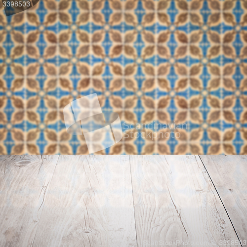 Image of Wood table top and blur vintage ceramic tile pattern wall