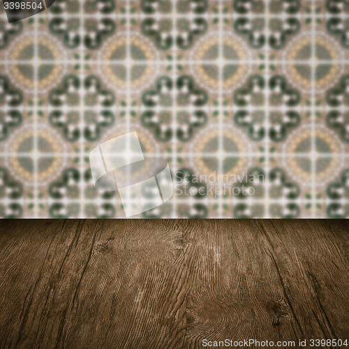 Image of Wood table top and blur vintage ceramic tile pattern wall