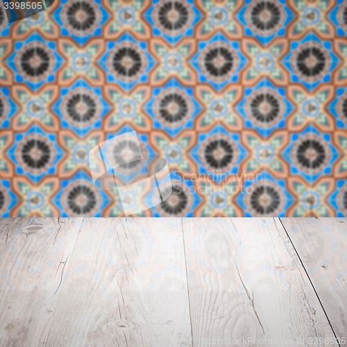 Image of Wood table top and blur vintage ceramic tile pattern wall