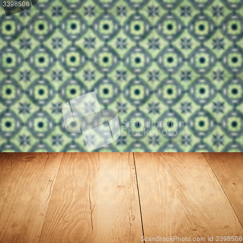 Image of Wood table top and blur vintage ceramic tile pattern wall