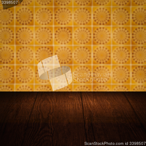 Image of Wood table top and blur vintage ceramic tile pattern wall