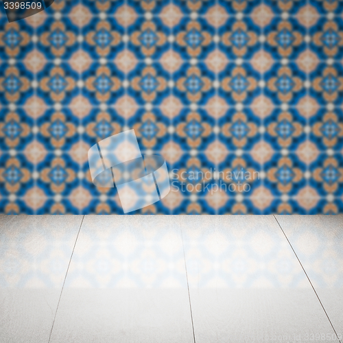 Image of Wood table top and blur vintage ceramic tile pattern wall