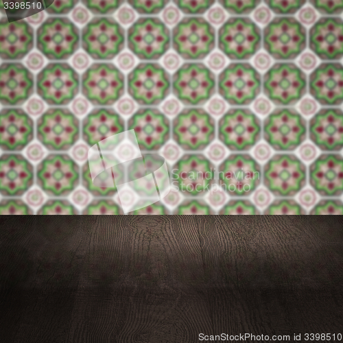 Image of Wood table top and blur vintage ceramic tile pattern wall