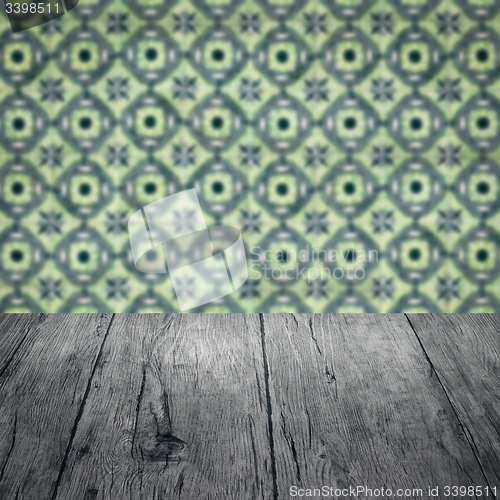 Image of Wood table top and blur vintage ceramic tile pattern wall