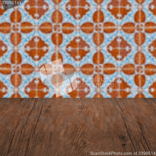 Image of Wood table top and blur vintage ceramic tile pattern wall