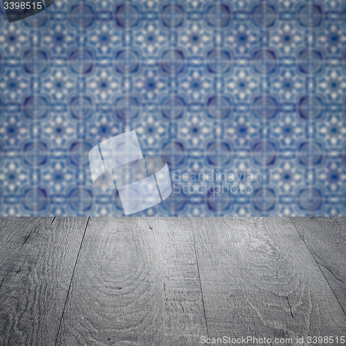 Image of Wood table top and blur vintage ceramic tile pattern wall