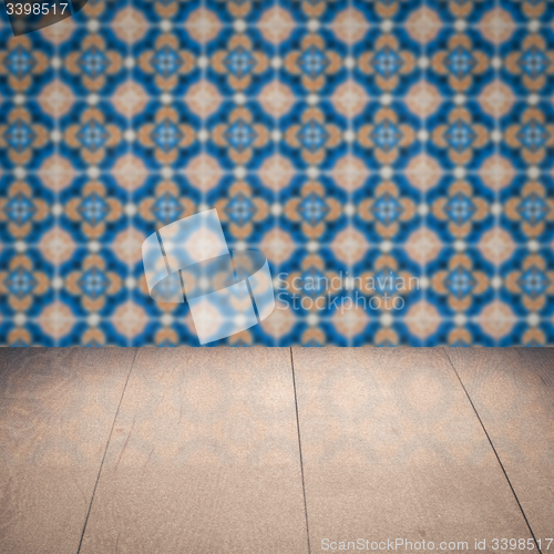 Image of Wood table top and blur vintage ceramic tile pattern wall