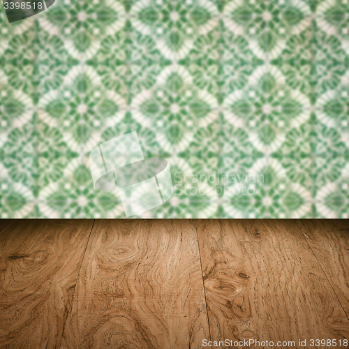 Image of Wood table top and blur vintage ceramic tile pattern wall