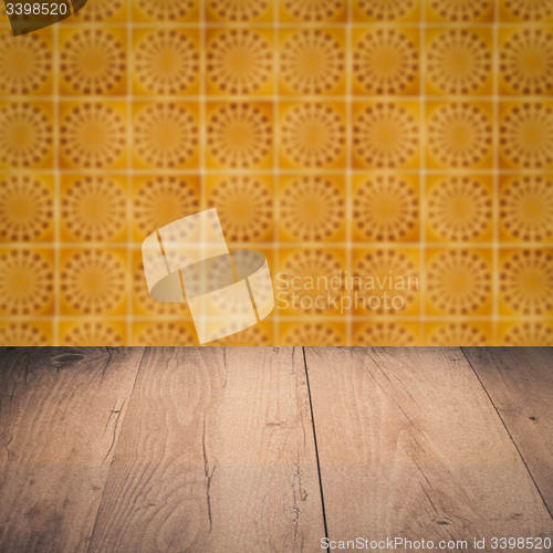 Image of Wood table top and blur vintage ceramic tile pattern wall