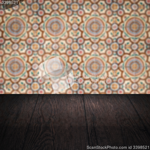 Image of Wood table top and blur vintage ceramic tile pattern wall