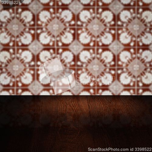 Image of Wood table top and blur vintage ceramic tile pattern wall