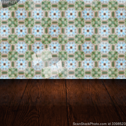 Image of Wood table top and blur vintage ceramic tile pattern wall