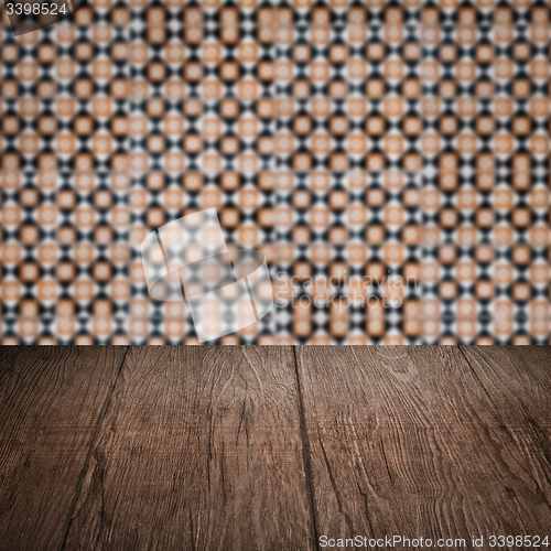 Image of Wood table top and blur vintage ceramic tile pattern wall