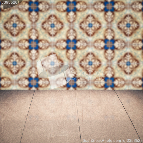Image of Wood table top and blur vintage ceramic tile pattern wall
