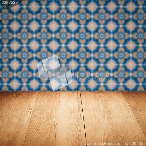 Image of Wood table top and blur vintage ceramic tile pattern wall
