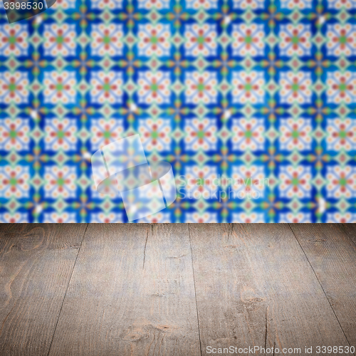 Image of Wood table top and blur vintage ceramic tile pattern wall