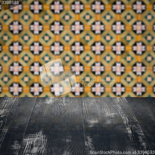 Image of Wood table top and blur vintage ceramic tile pattern wall