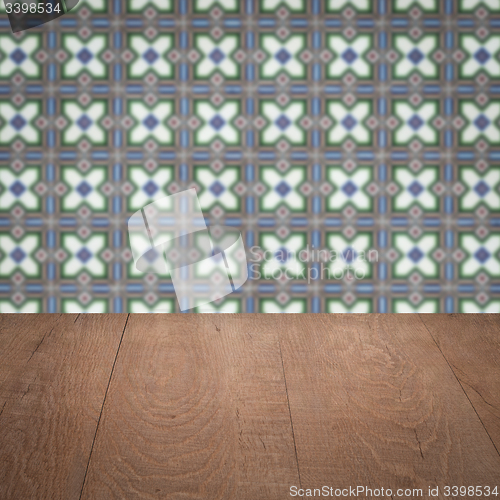 Image of Wood table top and blur vintage ceramic tile pattern wall