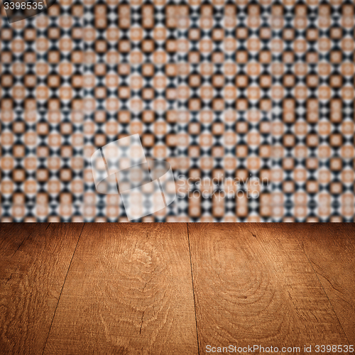 Image of Wood table top and blur vintage ceramic tile pattern wall