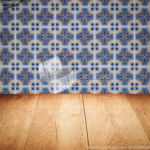 Image of Wood table top and blur vintage ceramic tile pattern wall