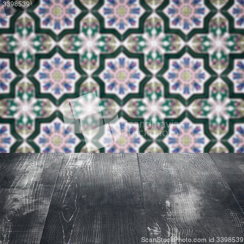 Image of Wood table top and blur vintage ceramic tile pattern wall