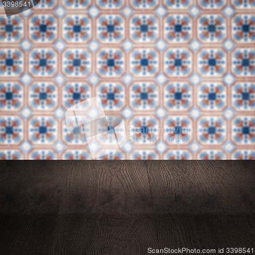 Image of Wood table top and blur vintage ceramic tile pattern wall