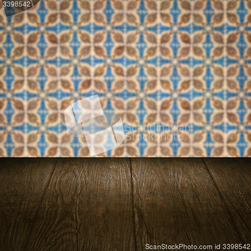 Image of Wood table top and blur vintage ceramic tile pattern wall