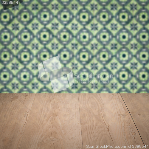 Image of Wood table top and blur vintage ceramic tile pattern wall