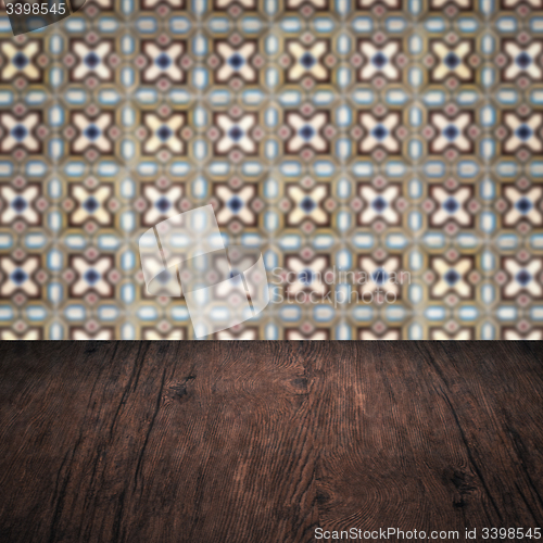 Image of Wood table top and blur vintage ceramic tile pattern wall