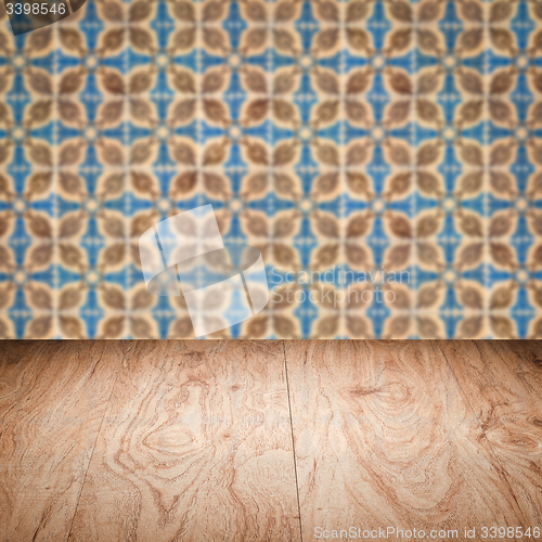 Image of Wood table top and blur vintage ceramic tile pattern wall