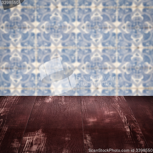 Image of Wood table top and blur vintage ceramic tile pattern wall