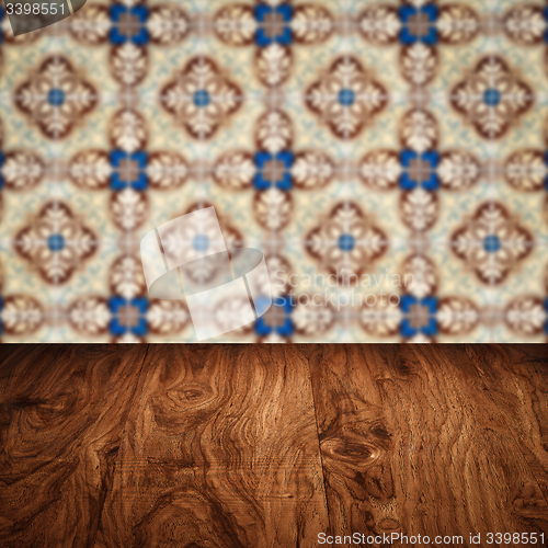 Image of Wood table top and blur vintage ceramic tile pattern wall