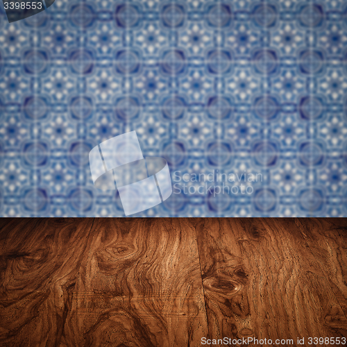 Image of Wood table top and blur vintage ceramic tile pattern wall