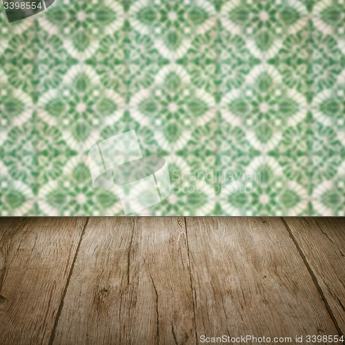 Image of Wood table top and blur vintage ceramic tile pattern wall