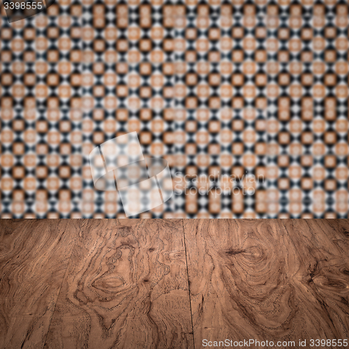 Image of Wood table top and blur vintage ceramic tile pattern wall